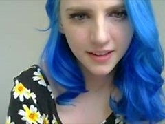 Blue haired girl in flowers plays with tits