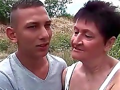 Busty grandma fucking her young boyfriend outdoor