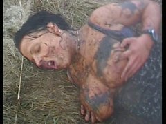 Creepy dude fucks sexy brunette in the mud on a field